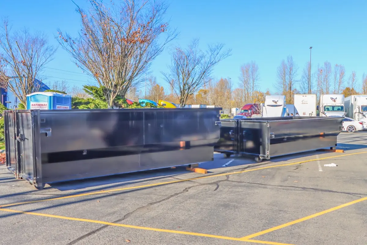 Professional dumpster rental service with roll-off container on residential driveway in Kayenta